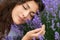 Beautiful young woman portrait on lavender flowers background, face closeup