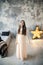 Beautiful young woman posing in bedroom on gray wall background and bright luminous decorative star