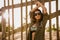 Beautiful young woman posing near a wood fence