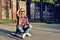 Beautiful young woman posing with a skateboard, fashion lifestyle at sunset