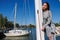 Beautiful young woman posing on yacht. Model is sailing on board