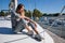 Beautiful young woman posing on yacht. Model is sailing on board