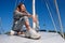 Beautiful young woman posing on yacht. Model is sailing on board