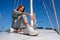 Beautiful young woman posing on yacht. Model is sailing on board