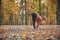 Beautiful young woman practices yoga asana Ardha Uttanasana - Half Standing Forward Fold pose on the wooden deck in the