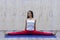 Beautiful young woman practices yoga asana Samakonasana Straight angle posture