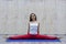 Beautiful young woman practices yoga asana Samakonasana Straight angle posture