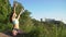 Beautiful young woman practices yoga moves and positions outdoors on an incredible clifftop.