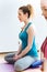 Beautiful young woman practicing yoga at home. Vajrasana pose.