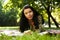 Beautiful young woman reading outdoor