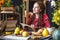 Beautiful young woman reading romantic book in autumn atmosphere. Rustic table with yellow flowers and a stack of books