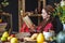 Beautiful young woman reading romantic book in autumn atmosphere. Rustic table with yellow flowers and a stack of books