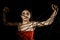 Beautiful young woman in red dress entangled in a rope cobweb on a black background