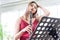 Beautiful young woman in a red dress playing the clarinet .,Classical musician oboe playing