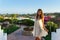 Beautiful young woman relaxing in a luxury hotel in a white dress. summer holidays and relaxation