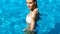 Beautiful young woman resting in the swimming pool