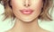 Beautiful young woman`s lips closeup. Plastic surgery, fillers, injection. Part of the model girl face, youth concept