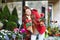 Beautiful young woman selecting flowers market