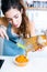 Beautiful young woman serving mashed vegetables in a bowl.