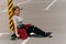 Beautiful young woman in a shirt with a longboard in the parking lot on the road in the city in sunny weather