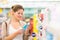 Beautiful young woman shopping for cosmetics in a grocery store