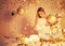 Beautiful young woman sitting in decorated holiday room with gifts balls on Christmas background! Merry Christmas