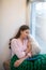 Beautiful young woman sleeping on the windowsill