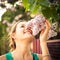 Beautiful young woman smelling jasmin flowers