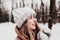 Beautiful young woman in snowy fancy winter woodland. Christmas forest, trees