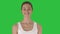 Beautiful young woman stretch oneself in the morning on a green screen, chroma key.