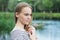 Beautiful young woman in a striped dress on lake