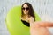 Beautiful young woman in swimming pool making selfie with inflatable ring wearing sunglasses. Vacation concept.