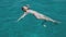 Beautiful young woman swims in clear blue water near Formentera or Ibiza islands around luxury yach. Slow motion