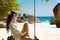 Beautiful young woman on a swing resting on exotic beach with white sand by sea blue water, seashore. Wellness. Rock. Lifestyle.