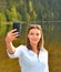 Beautiful young woman taken picture of herself, selfie