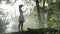 Beautiful young woman testing VR equipment in the forest -