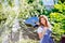 Beautiful young woman in traditional bavarian dress holding guit