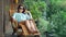 Beautiful young woman traveler resting in the mountains near the river