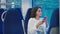 beautiful young woman is travelling by train, sitting near window, holding smartphone in hands