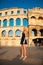 beautiful young woman turist taking photos of roman arena in Pula croatia