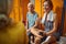 Beautiful young woman with two senior women in gym locker room having a conversation before workout session