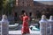 Beautiful young woman in a typical Moroccan red suit, embroidered with gold and silver threads, posing next to the boats in the