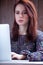 beautiful young woman typing text on the wonderful wooden background