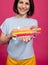 Beautiful young woman uses an oral care kit consisting of a tongue scraper, single tufted and interdental brush