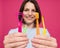 Beautiful young woman uses an oral care kit consisting of a tongue scraper, single tufted and interdental brush