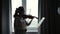 Beautiful young woman violinist plays the violin at home