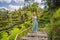 Beautiful young woman walk at typical Asian hillside with rice farming, mountain shape green cascade rice field terraces