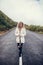 Beautiful young woman walking on empty road