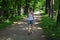 Beautiful young woman walking in summer park