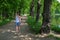 Beautiful young woman walking in summer park